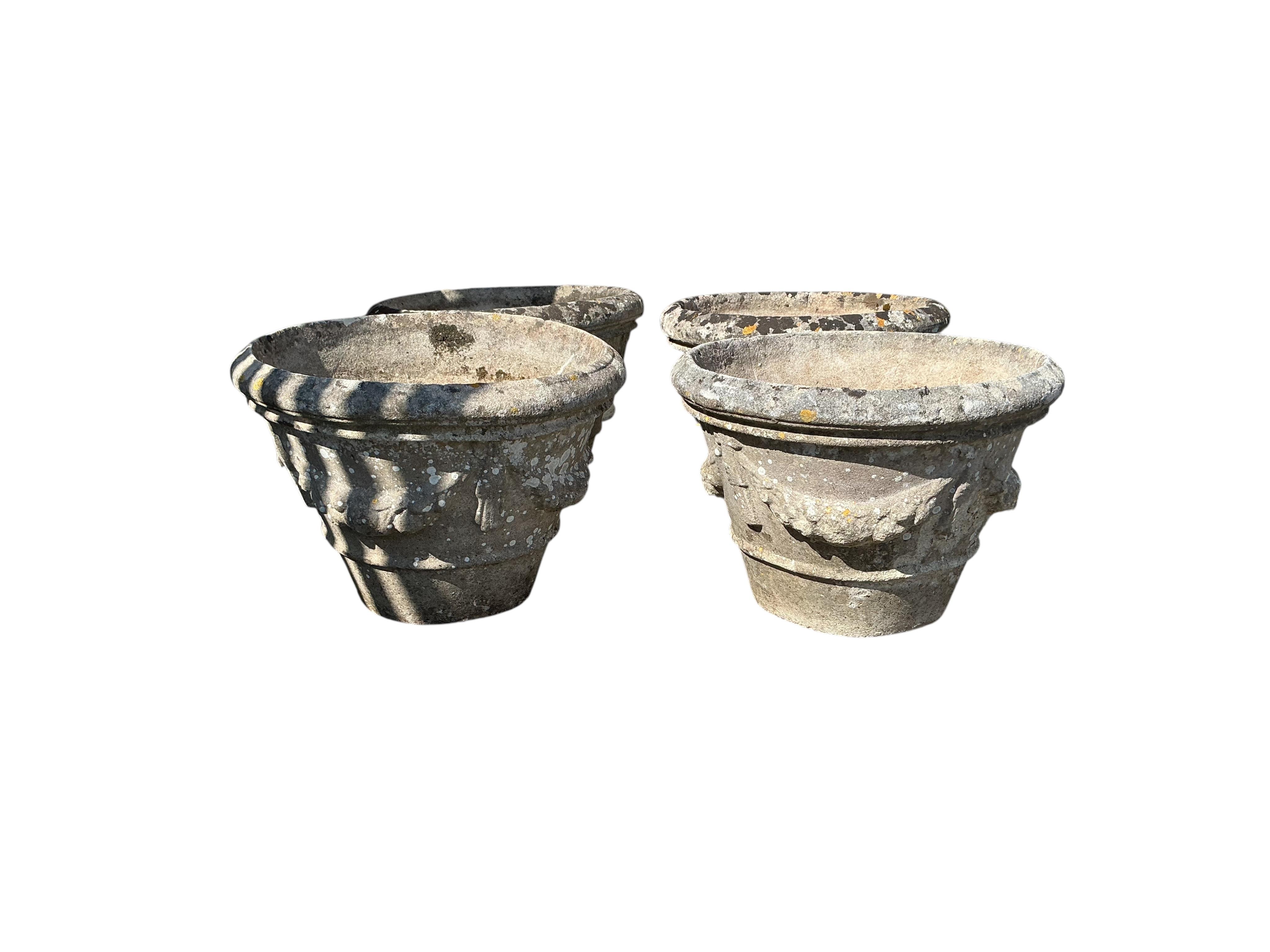 A set of four circular reconstituted stone garden planters, diameter 49cm, height 34cm